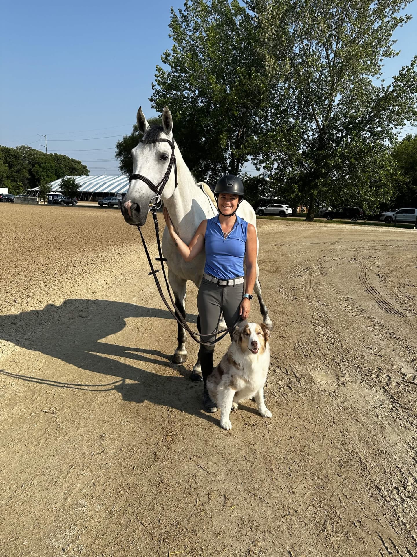 Dr. Shana Winkel standing with her horse and her dog